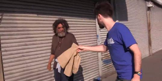 Photo: Still of man giving Abercrombie & Fitch clothes to the homeless (gkarber via YouTube)