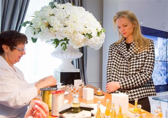 Assistant general manager Christian Dior Couture Delphine Arnault, right, looks a Dior perfume during his visit of