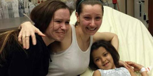 Photo: Amanda Berry, center, hugs her sister Beth Serrano and daughter Jocelyn at a Cleveland hospital on May 6 (Courtesy of 19ActionNews via Facebook)