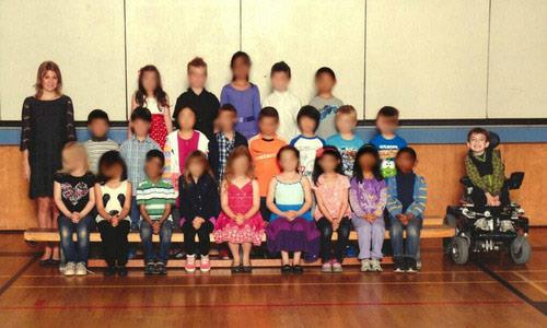 Photo: Class photo shows shows 7-year-old Miles Ambridge separated from the rest of his 22 classmates. / via Handout 