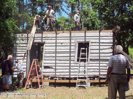 Photo: In this Monday, May 13, 2013 photo, workers remove roofing from a slave cabin on Edisto Island, S.C. (AP Photo/Bruce Smith)