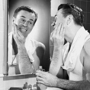 A vintage photo of a man shaving // Photo: Corbis 