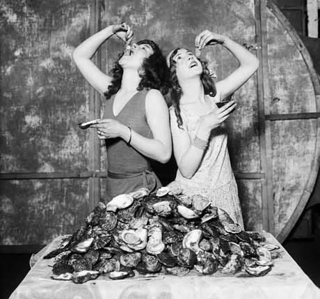 Vintage photo of women eating oysters // Photo: Courtesy Corbis 