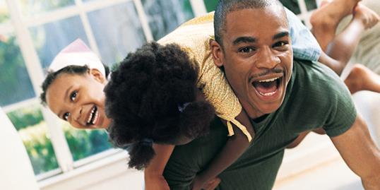 Dad roughhousing with kid