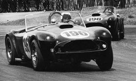 Bob Holbert leads Cobra teammate Ken Miles through turn nine at Mazda Raceway Laguna Seca in June 1963. This was the Cobra team's first USRRC Manufacturer's Cup win. Photo: Monterey.
