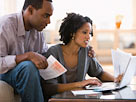 Image: Couple paying bills using laptop (© Jose Luis Pelaez Inc/Blend Images/Getty Images)