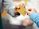 Image: Customer Giving Clerk Credit Card (© Fuse/Getty Images)
