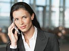Image: Businesswoman on cellphone (© Corbis)