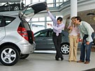 Image: Car salesman showing couple new silver hatchback in car showroom © Juice Images/Cultura/Getty Images