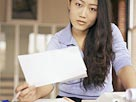 Image: Woman with paperwork (© Brand X/SuperStock)