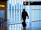 Image: Man pulling suitcase in airport © Keith Brofsky/UpperCut Images/Getty Images