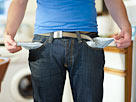 Image: Man holding out empty pockets. (© Dougal Waters/Photodisc/Getty Images)