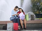 Image: Mother and daughter with shopping bags (© Big Cheese Photo/SuperStock)