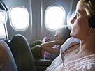 Image: Mother and daughter watching in-plane movie © Ron Levine/Photodisc/Getty Images