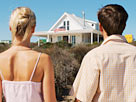 Image: Rear view of a mid adult couple holding hands looking at a house (© Stockbyte/Getty Images)
