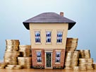 Image: House with coins (© Digital Vision/Getty Images)