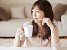 Image: Young woman drinking a cup of coffee (© Opus/amanaimagesRF/Getty Images)