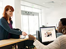 Image: Female customer handing credit card to receptionist (© PhotoAlto/Frederic Cirou/PhotoAlto/Getty Images)