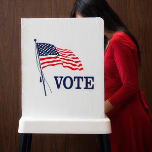 Voter voting in polling place Hill Street Studios/Blend Images/Getty Images