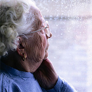 Elderly Woman Looking Out a Window © Keith Brofsky, Photodisc, Getty Images