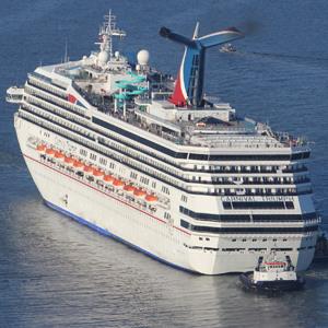 The Carnival Triumph cruise ship is towed toward the port of Mobile, Ala. last week. 
© Lyle Ratliff/Reuters
