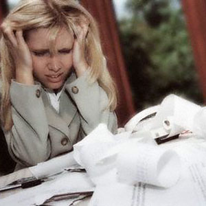 Image: Woman with paperwork (© Corbis)