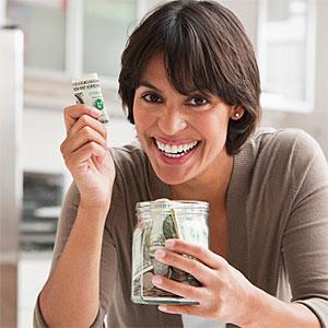 Woman with jar of cash © SelectStock, the Agency Collection, Getty Images