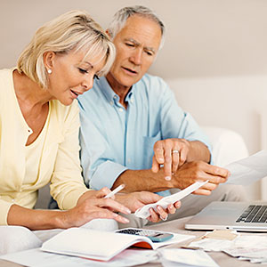 Image: Mature couple calculating expenses © Abel Mitja Varela, the Agency Collection, Getty Images