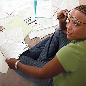Woman with paperwork (© Comstock Select/Corbis)