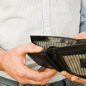 image: Man holding empty wallet © CharlesSturge.com, Image Source, Getty Images