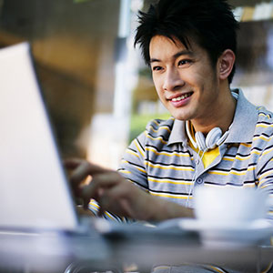 Man with laptop © Ken Seet/SuperStock