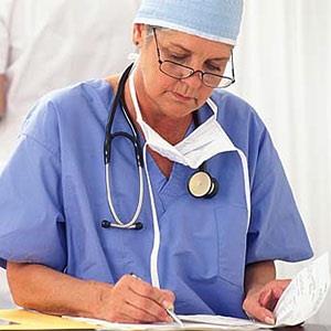 Image: Surgeon with paperwork (© Creatas Images/JupiterImages Corporation)