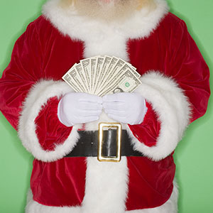 Santa Claus with cash © Tetra Images/Jupiterimages