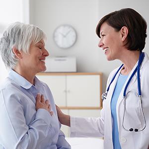 Doctor reassuring patient in exam room © LWA/Getty Images