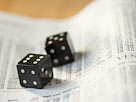 Image: Dice on stock listings (Â© Kate Kunz/Corbis)