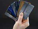Image: Woman holding set of fanned-out credit cards (Â© Sheer Photo Inc./Photodisc/Getty Images)