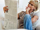 Image: Woman reading newspaper in livingroom Â© Tetra images/Getty Images