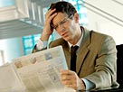 Image: Businessman reading newspaper © A. Chederros/ONOKY/Getty Images