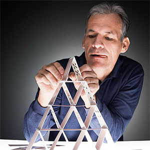 Mature man building house of cards, copyright amana productions inc., amana images, Getty Images