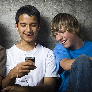 Image, Teens with MP3 player copyright RubberBall, SuperStock