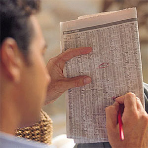 Image Stocks circled in newspaper copyright Digital Vision Getty Images