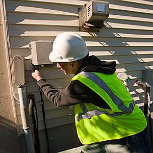 Image: Cable technician installing equipment on the side of a house -- Huntstock, Huntstock, Getty Images