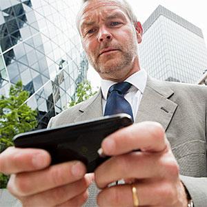 Businessman using smartphone -- Image Source, Image Source, Getty Images