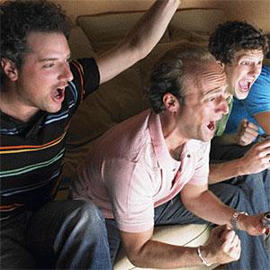 Men watching television, holding beers copyright Ghislain and Marie David de Lossy, Cultura, Getty Images