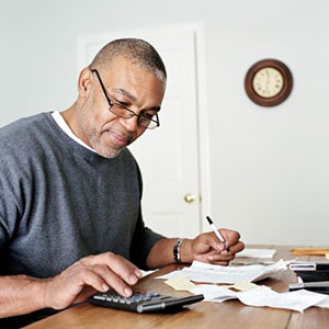 Image: Man with calculator ( Siri Stafford / Photodisc Red/Getty Images)
