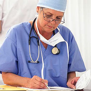 Surgeon with paperwork copyright Creatas Images, JupiterImages Corporation