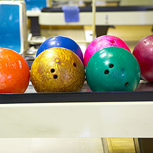 Bowling balls in bowling alley copyright Doable, amanaimagesRF, amana images, Getty Images