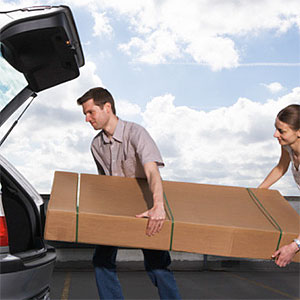 oung man and woman lifting box into car copyright Biddiboo, Stockbyte, Getty Images