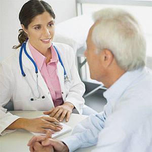 Doctor sitting in office with patient talking and smiling copyright Paul Bradbury, OJO Images, Getty Images