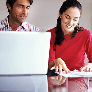 Couple with laptop copyright Image Source, SuperStock